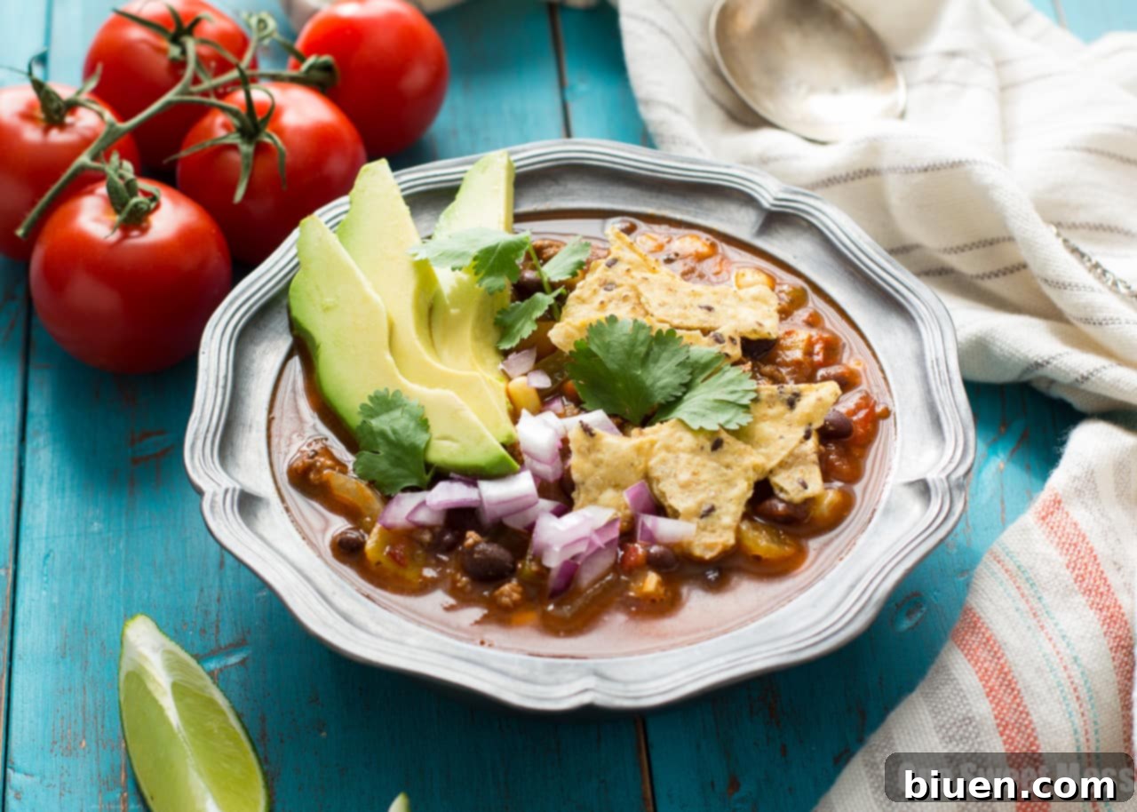 Fully Loaded Chorizo Taco Soup 4 Top-down view of Chorizo Taco Soup garnished with fresh cilantro and sour cream