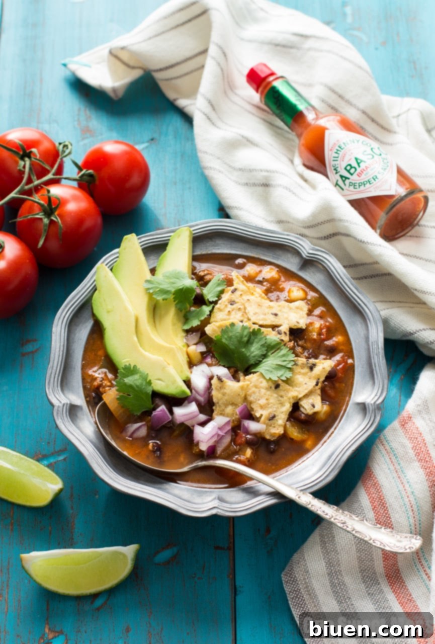 Fully Loaded Chorizo Taco Soup 6 Close-up of Chorizo Taco Soup with fresh cilantro and a dollop of sour cream