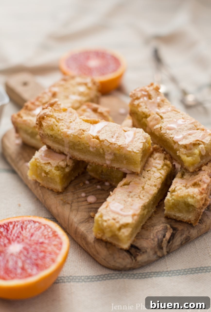 Blood Orange Jewel Bites, Vanilla Cloud Kiss 3 Close-up of the vibrant interior and crackled top of Blood Orange Bars, showcasing their juicy citrus essence