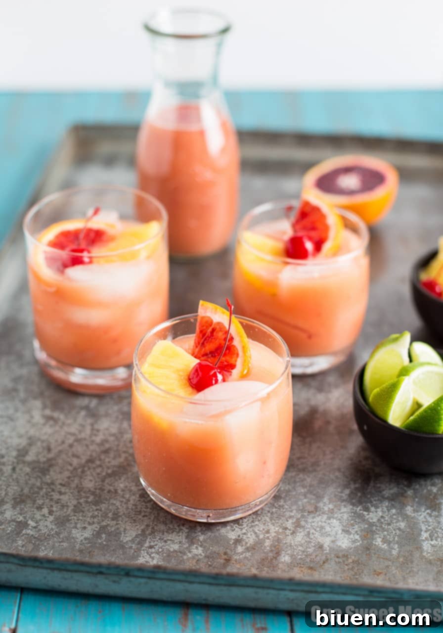 Blood Orange Coconut Mai Tai for Thirsty Thursday 2 Vibrant Blood Orange Coconut Mai Tai cocktail in a glass, garnished with a blood orange slice and cherry, ready for sipping.