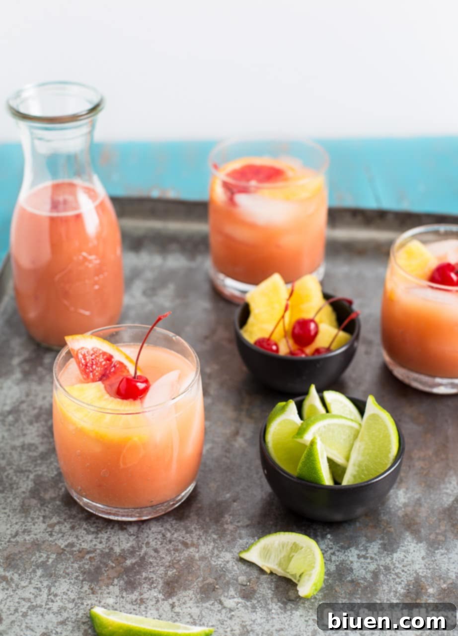 Blood Orange Coconut Mai Tai for Thirsty Thursday 5 A Blood Orange Coconut Mai Tai served in a hurricane glass with a colorful straw, garnished with a blood orange slice and a maraschino cherry.