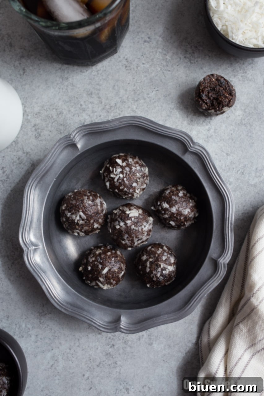 Blueberry Muffin Energy Bites stacked on a plate, ready to eat