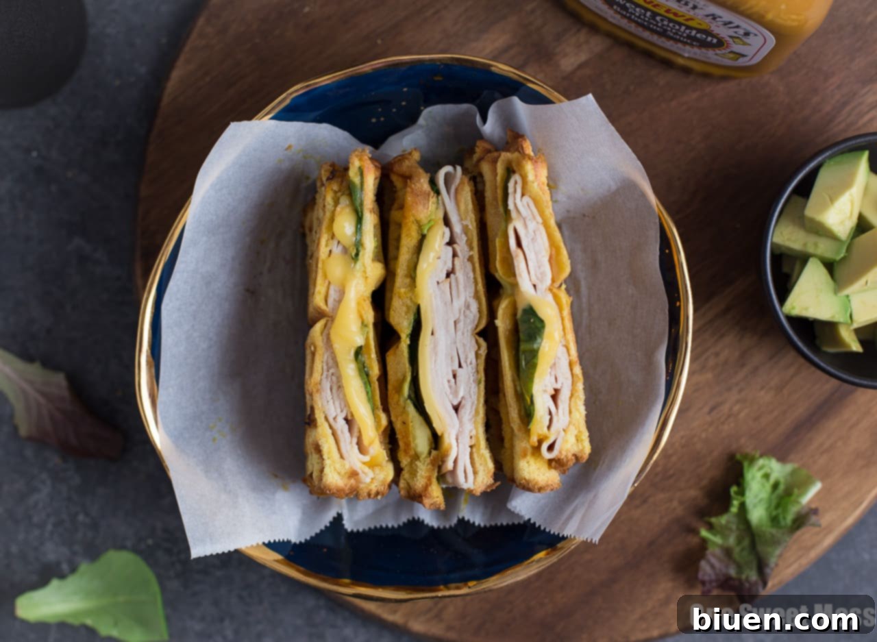 Waffle-Pressed Turkey Smoked Gouda Panini 3 Close-up of a Waffle Iron Turkey & Smoked Gouda Panini showing melted cheese and crispy bread