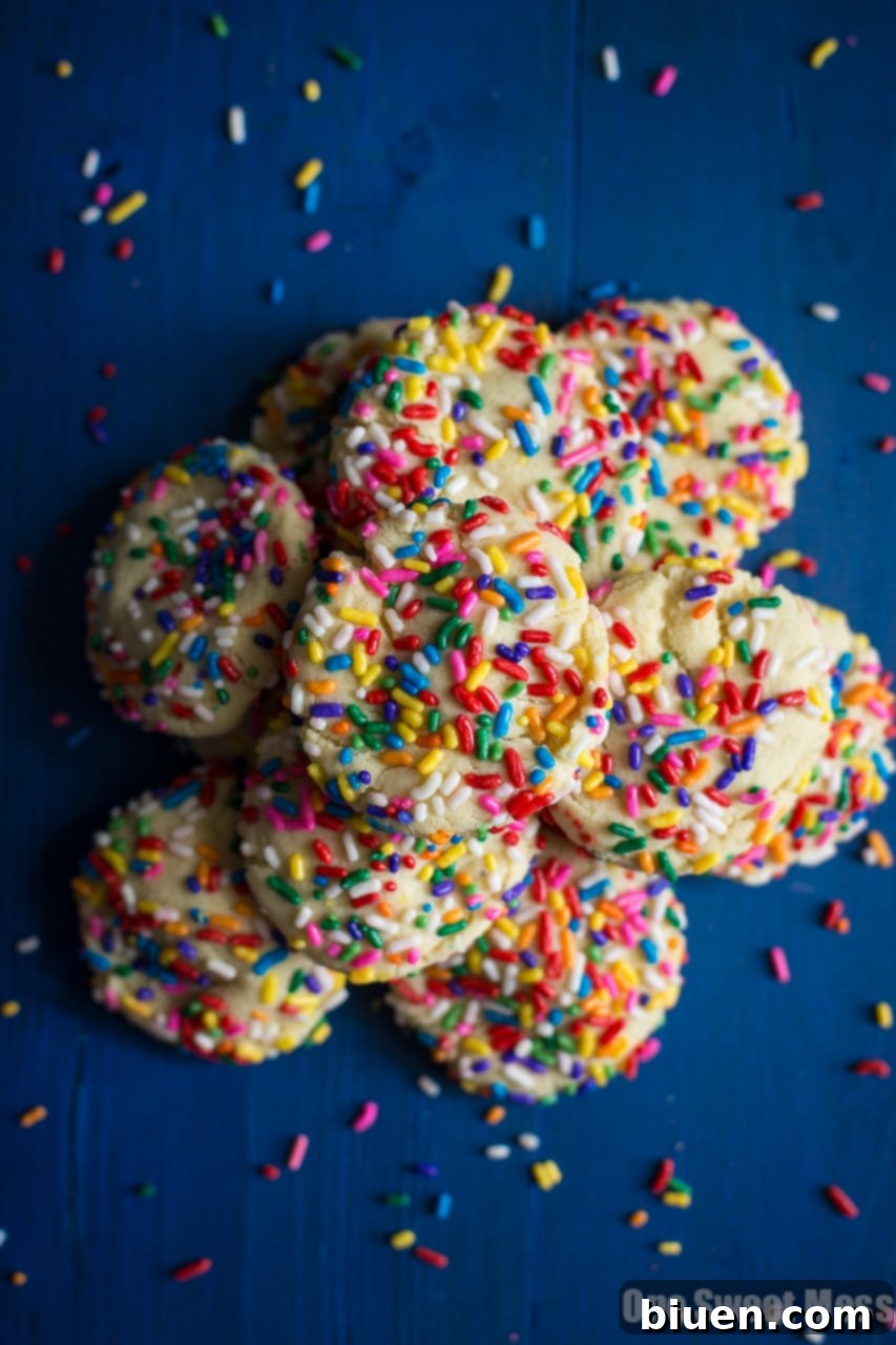 Confetti Cloud Sugar Cookies 4 Soft-Baked Funfetti Sugar Cookies arranged on a cooling rack, vibrant and inviting