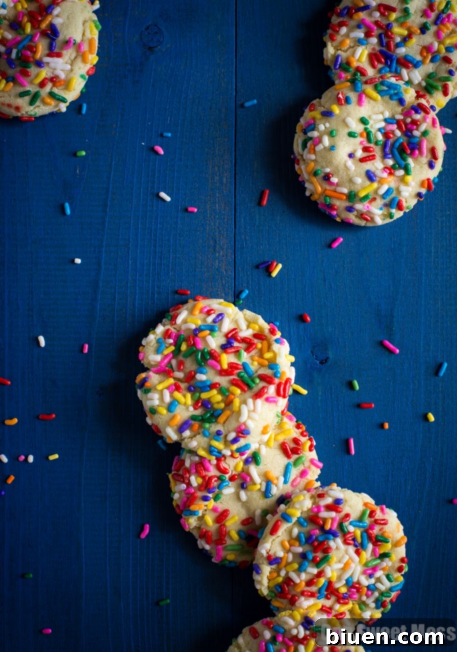 Confetti Cloud Sugar Cookies 5 A stack of soft-baked funfetti sugar cookies on a plate, ready to be enjoyed