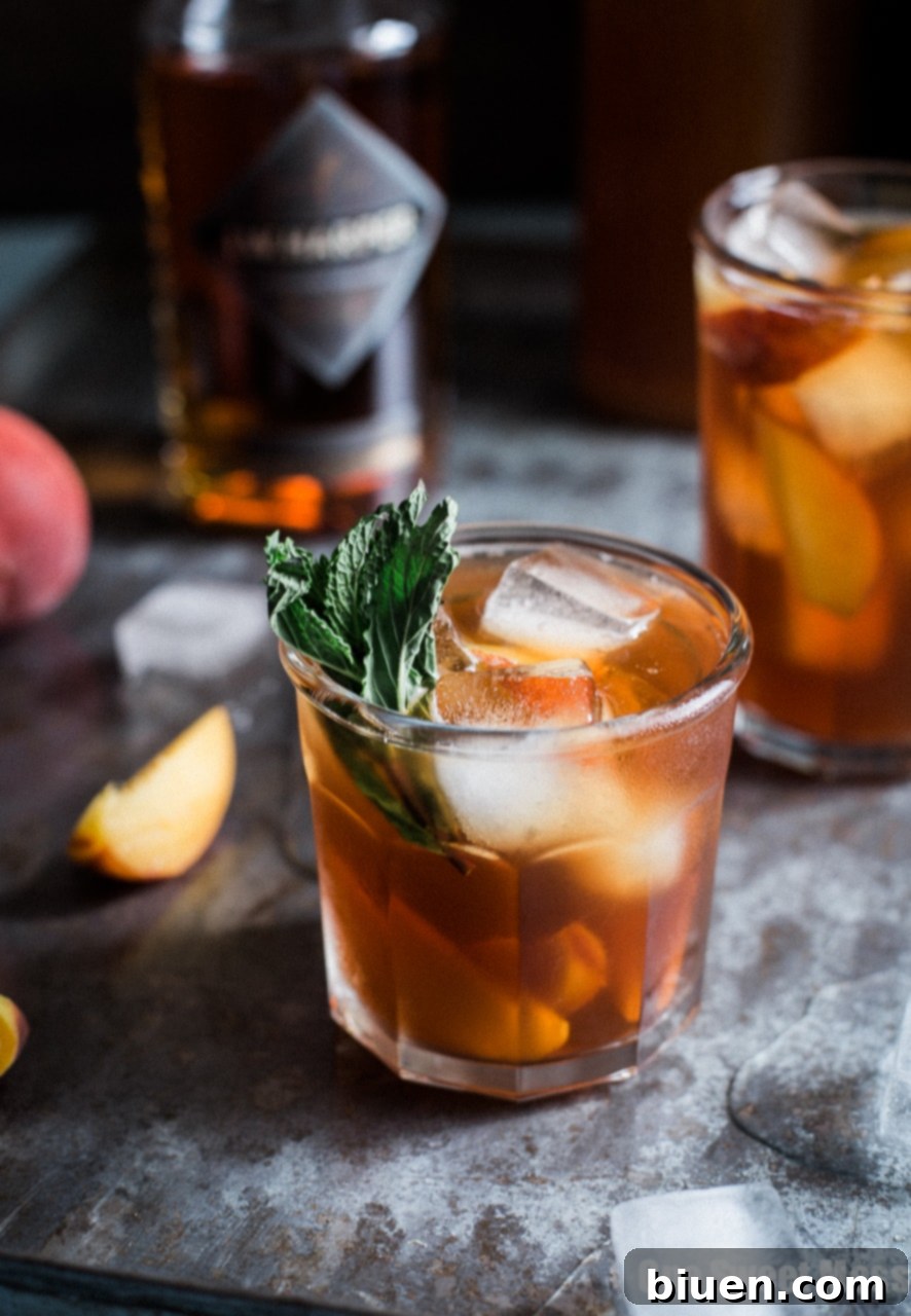 Close-up of a Peach Arnold Palmer with Bourbon in a mason jar