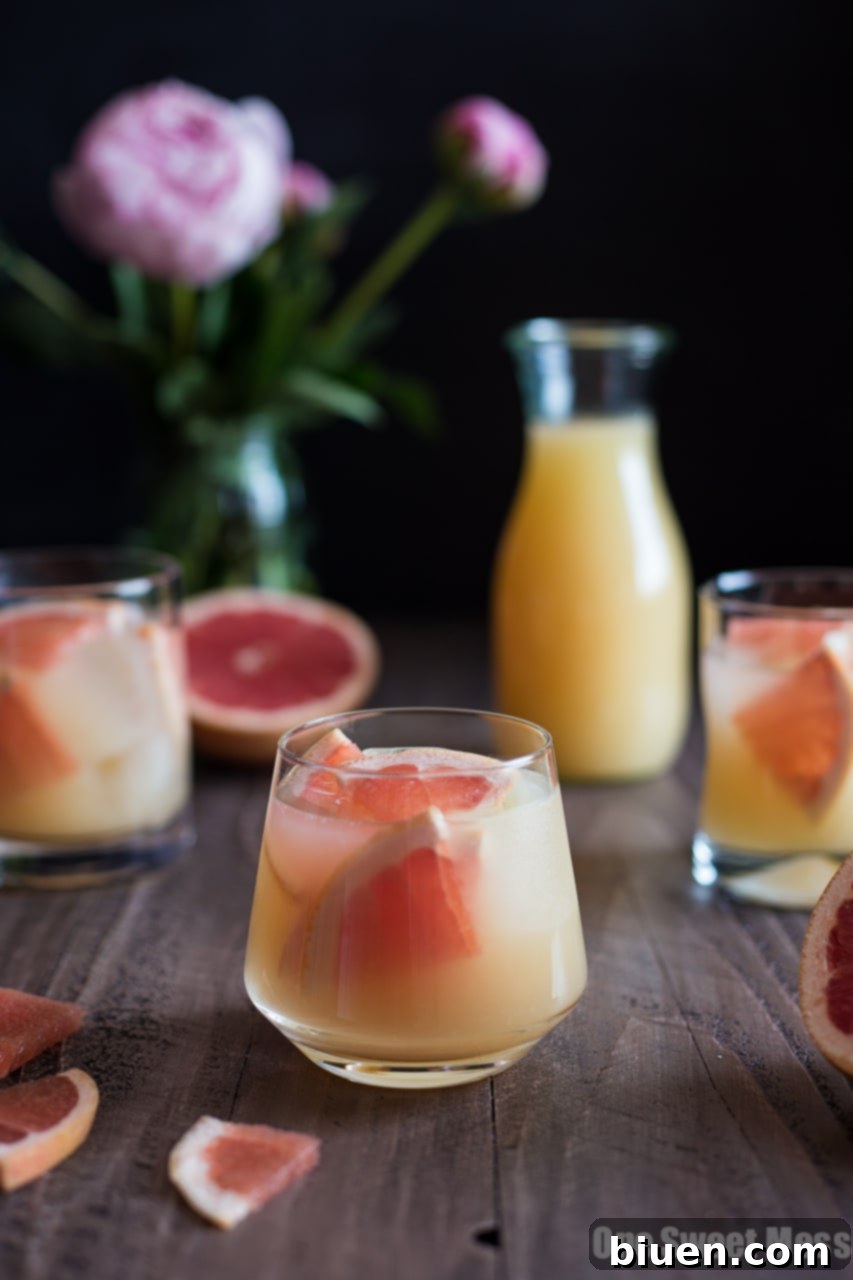 Refreshing Bourbon Grapefruit Cocktail served in a highball glass with a grapefruit wedge garnish