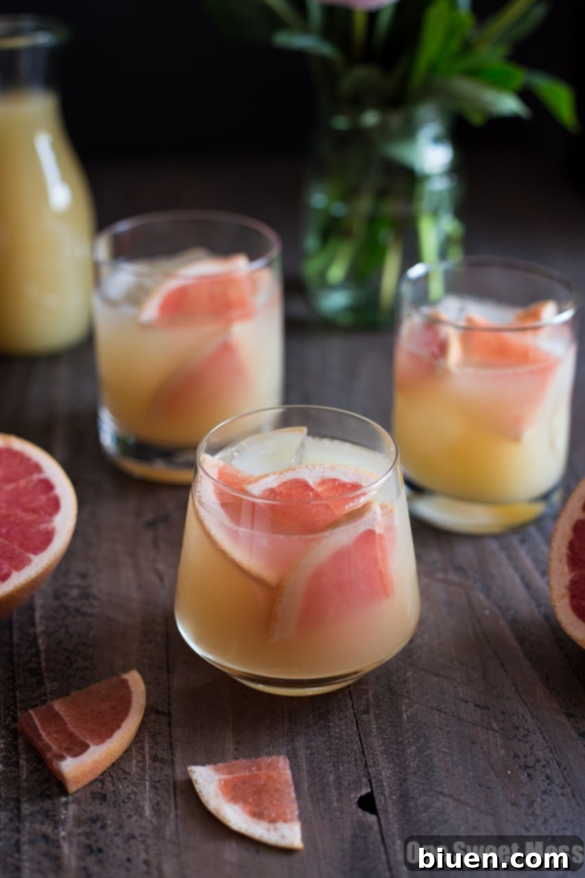 Finished Bourbon Grapefruit Cocktail with a grapefruit slice and rosemary garnish