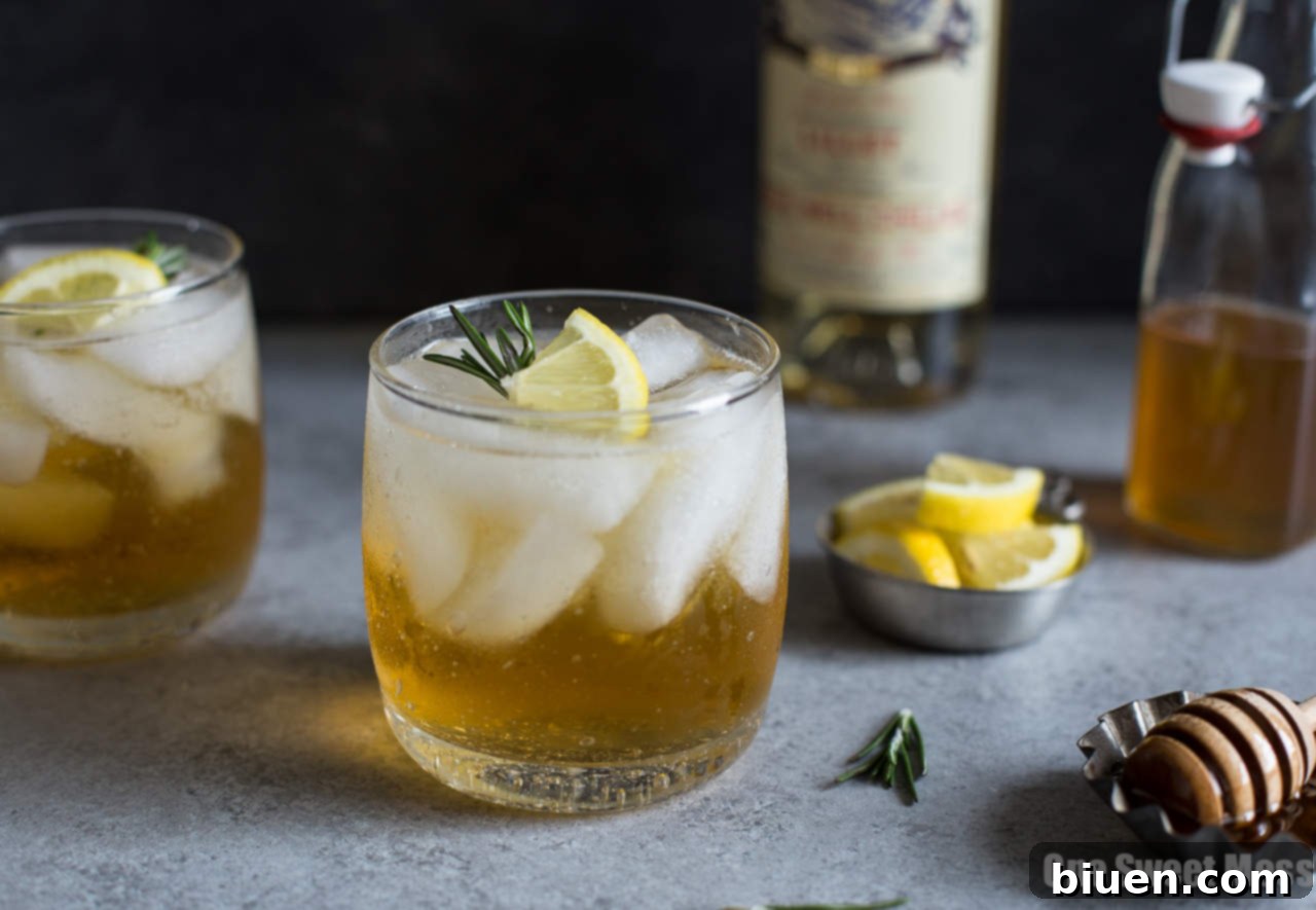 Close-up of a Honey Rosemary Lillet Spritzer with garnishes