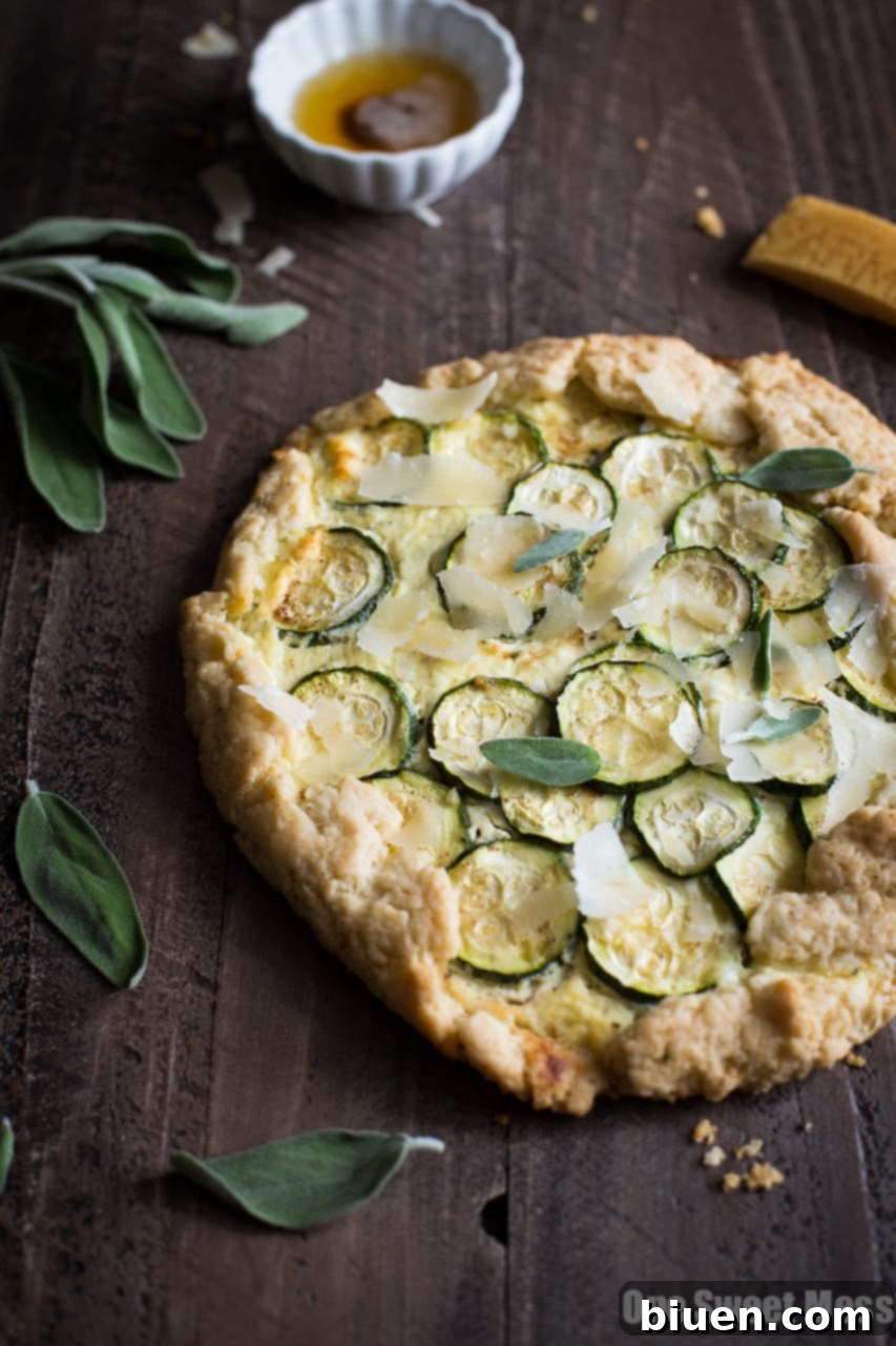 Rustic Summer Squash & Ricotta Galette with Sage Brown Butter on a wooden board, showcasing its golden crust and vibrant filling