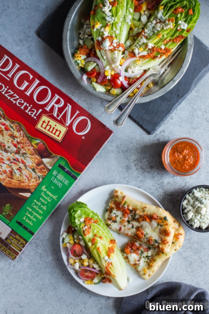 Overhead view of fresh ingredients for Grilled Corn & Tomato Salad, including grilled corn on the cob, ripe tomatoes, and greens