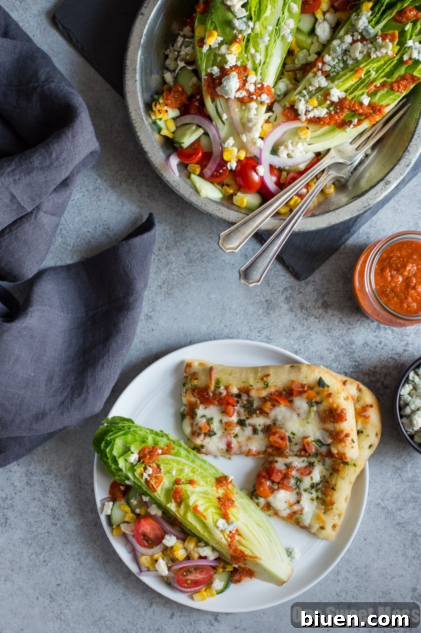 A colorful plate of Grilled Corn & Tomato Salad topped with blue cheese, ready to be served