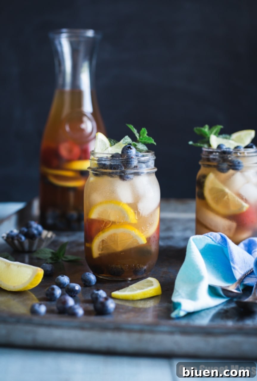 Blueberry Sweet Tea Lemonade Sangria, a refreshing summer drink in a glass with fresh fruit