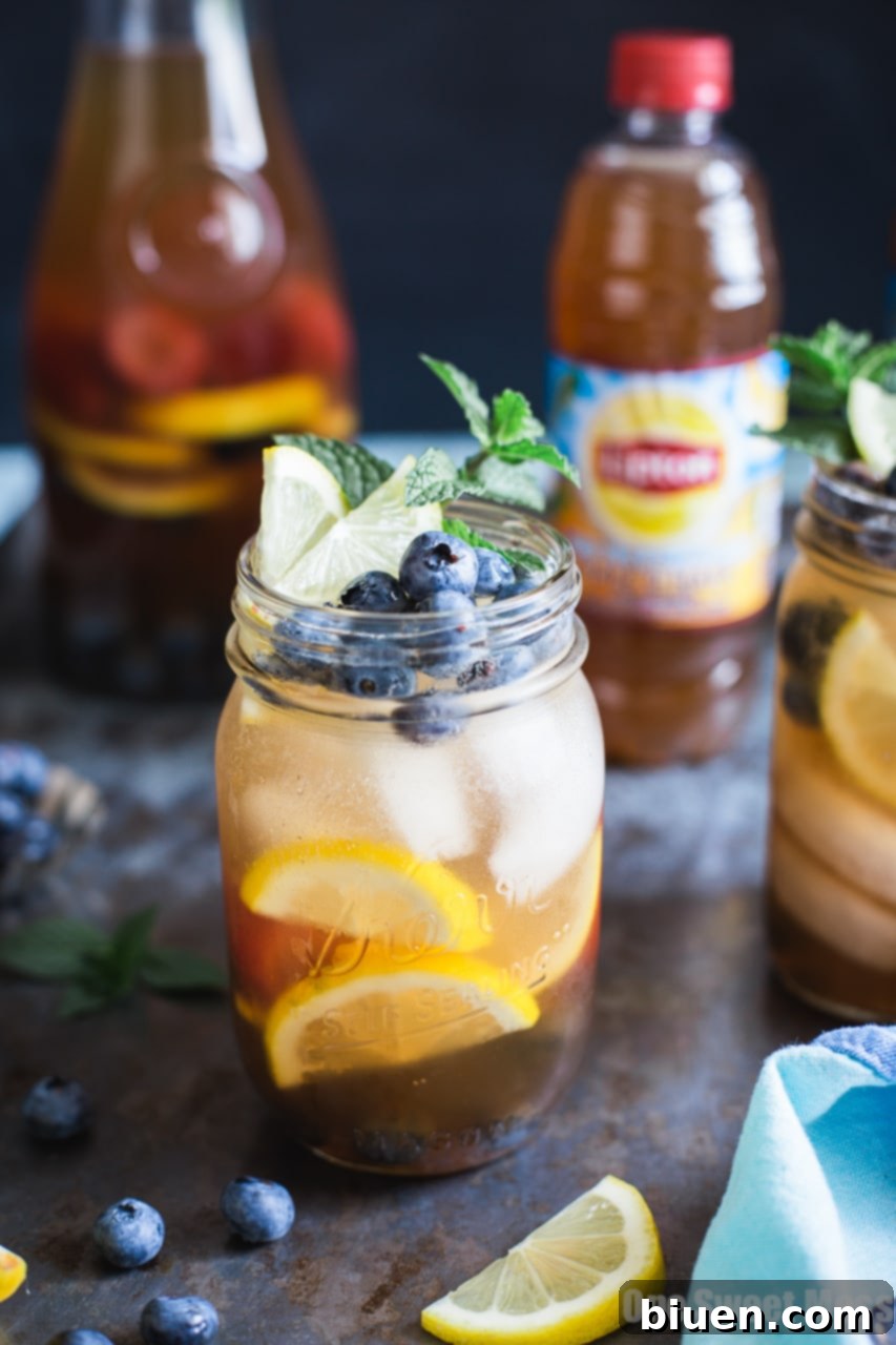 Pitcher of Blueberry Sweet Tea Lemonade Sangria with fresh fruit and glasses