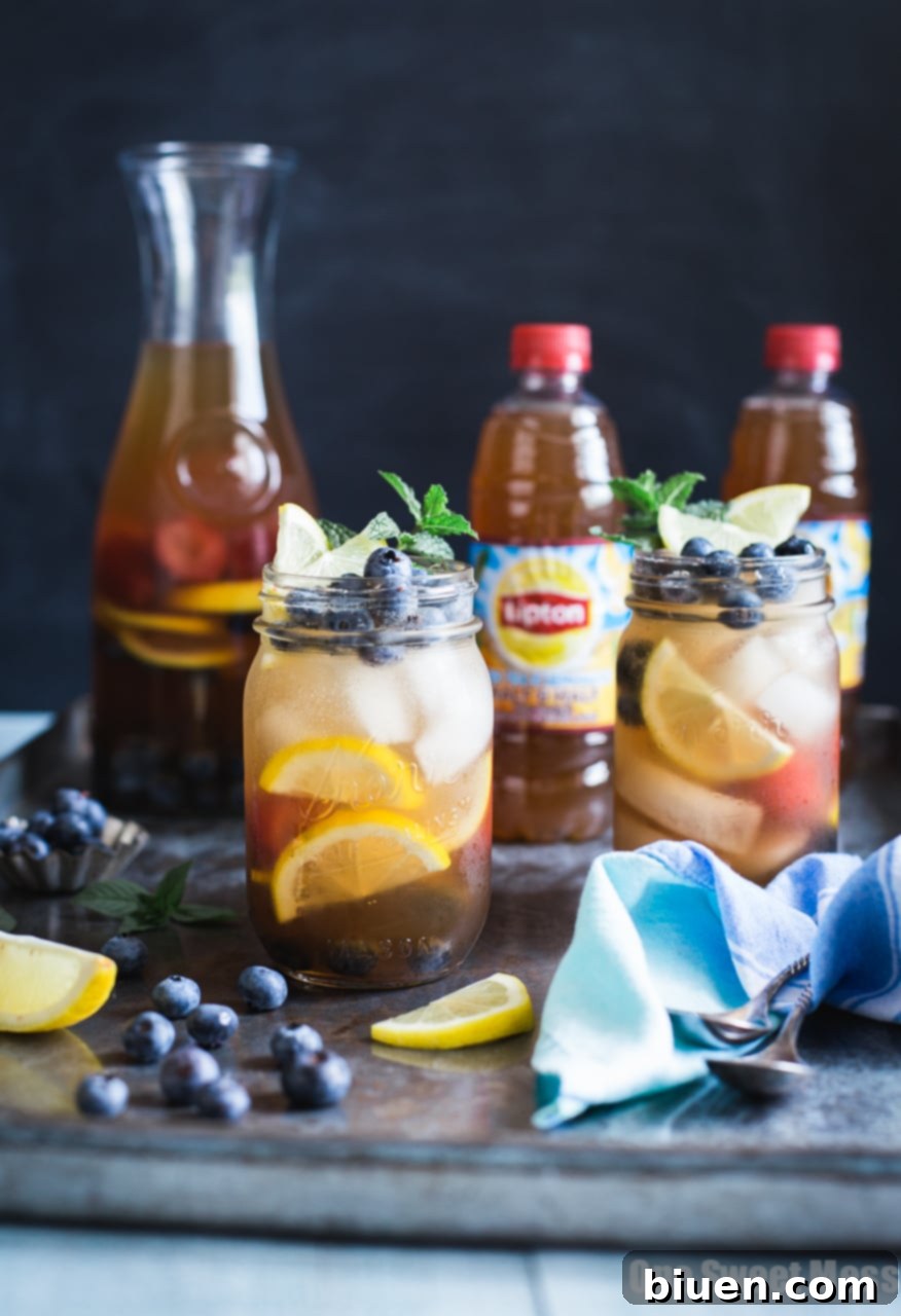 Friends enjoying Blueberry Sweet Tea Lemonade Sangria on a summer evening on a deck