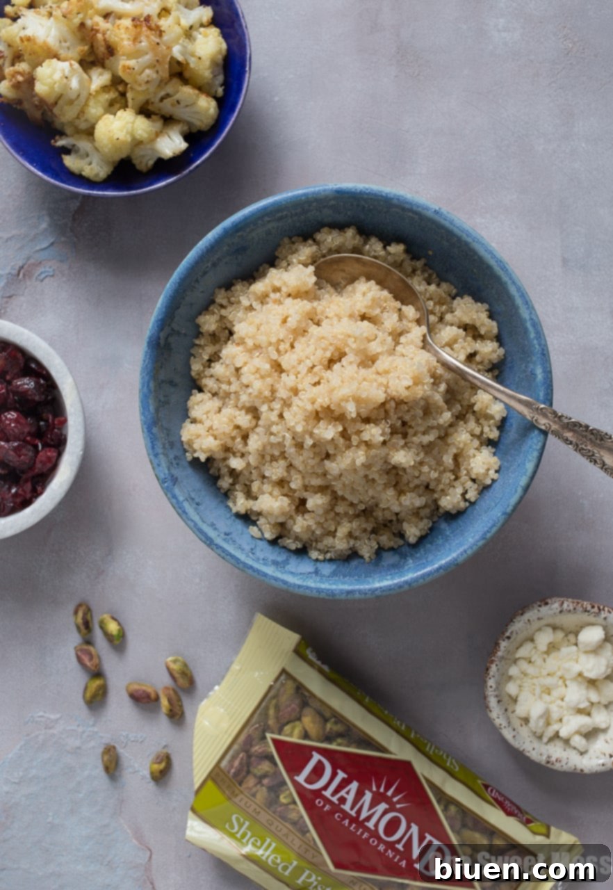A close-up of perfectly golden-brown roasted cauliflower florets with melted Parmesan cheese, freshly out of the oven