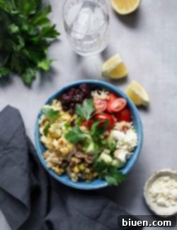 Final serving of Roasted Cauliflower Quinoa Salad with Lemon Tahini Dressing in a bowl with a fork