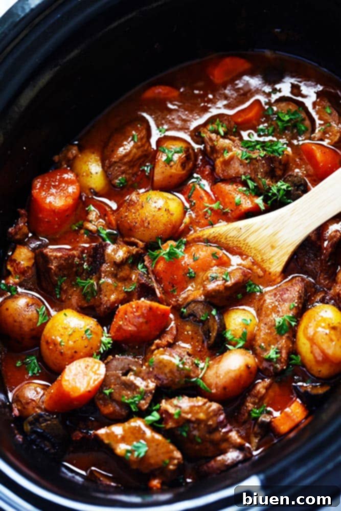 A hearty serving of Slow Cooker Beef Bourguignon, featuring tender beef, vegetables, and a rich sauce.