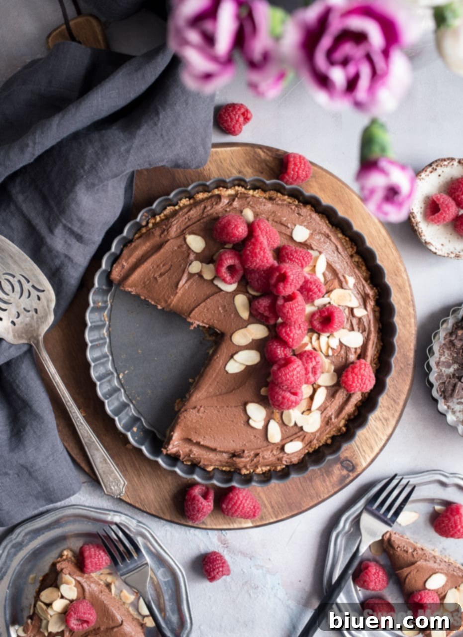 Decadent Vegan Gluten-Free Dark Chocolate Almond Tart 4 An appetizing view of the Dark Chocolate Almond Tart, beautifully garnished and ready to be served. This dessert is perfect for those seeking vegan, gluten-free, or dairy-free options.