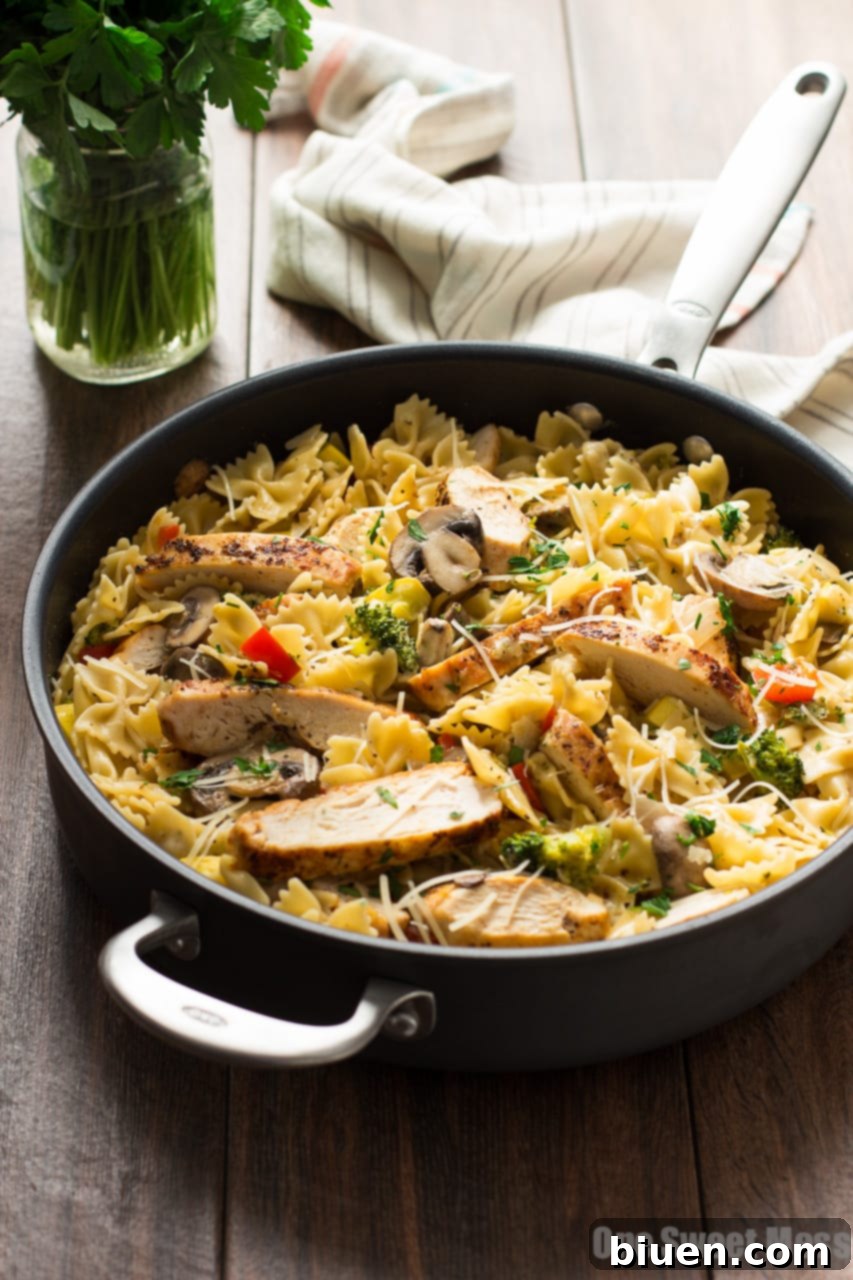 Quick and creamy Chicken Alfredo Primavera with fresh seasonal vegetables and bow-tie pasta.