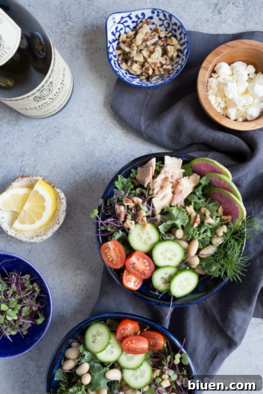 Fresh Kale, White Bean, and Tuna Salad with Lemon Vinaigrette served in a rustic bowl