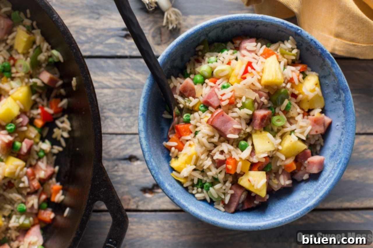 A serving of Pineapple Ham Fried Rice garnished with fresh scallions