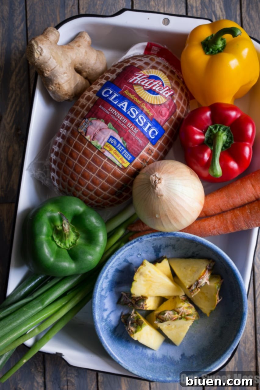 Ingredients being stir-fried in a pan for Pineapple Ham Fried Rice