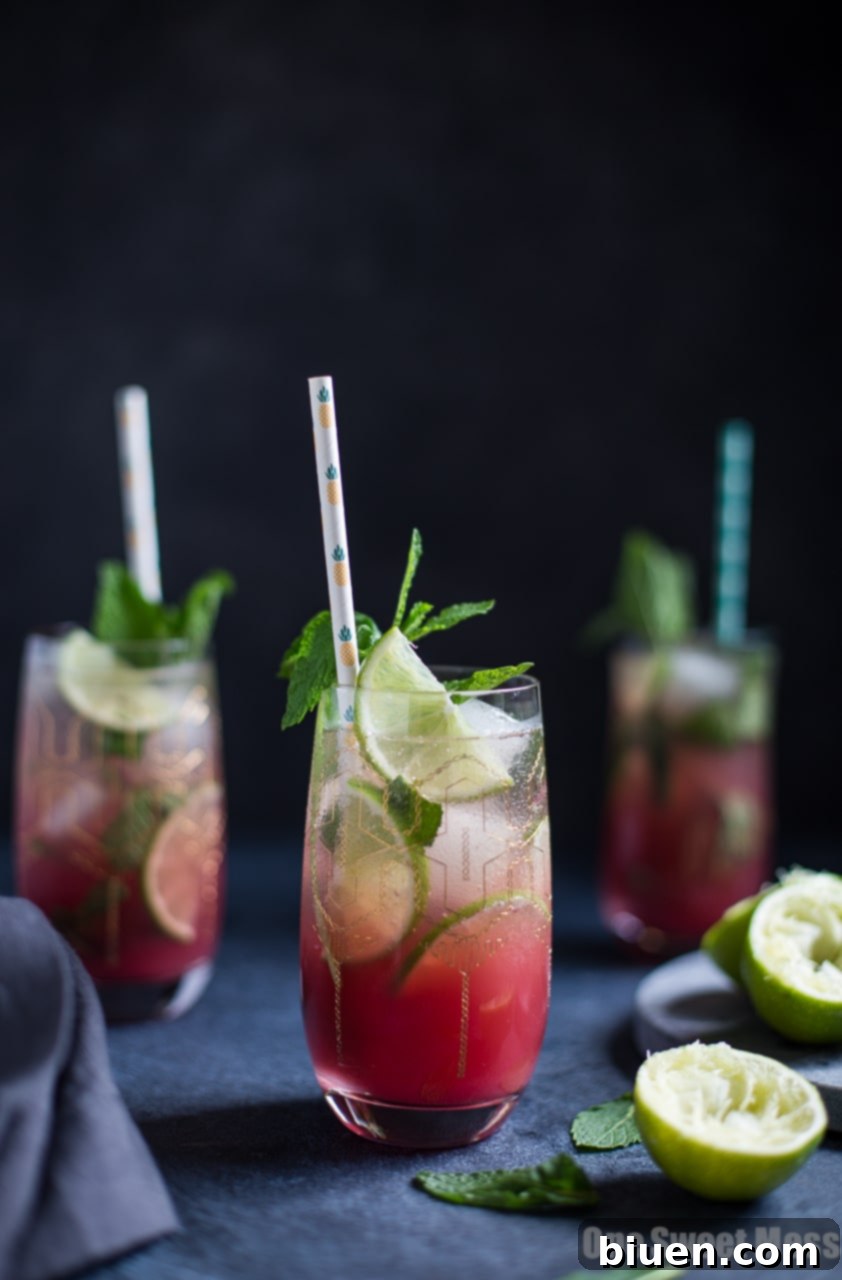 Vibrant Pineapple Cranberry Mojito cocktail in a glass with mint and fruit garnishes
