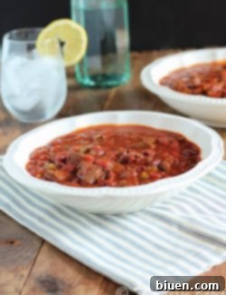 A beautifully presented bowl of Smoky Slow Cooker Venison Chili, ready to serve.