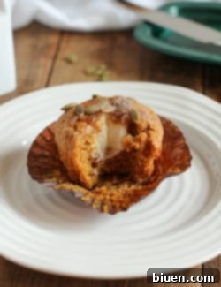 A freshly baked Sweet Cream Stuffed Pumpkin Muffin ready for enjoyment