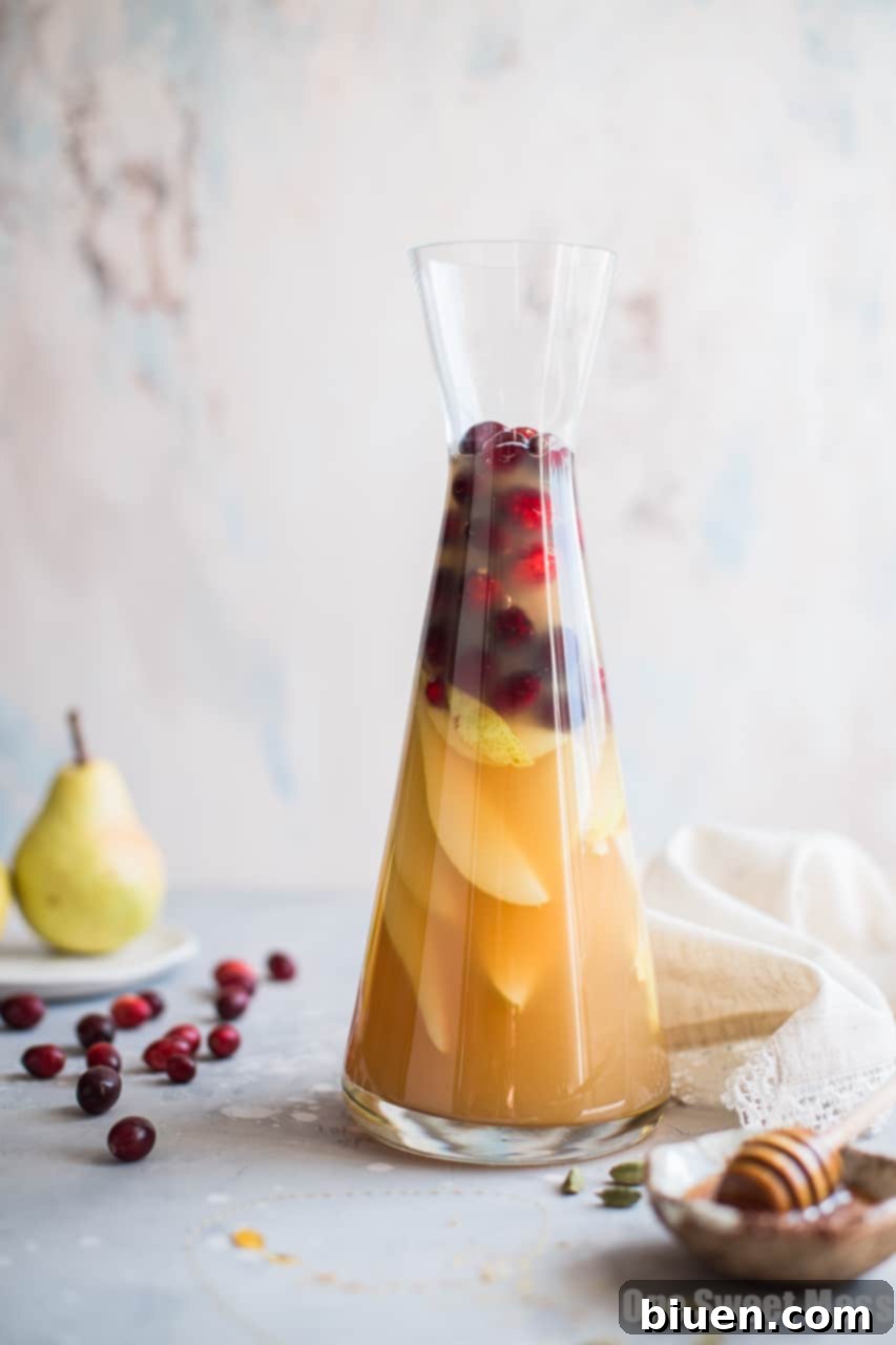 Close-up of pear slices and cranberries, key ingredients for the sangria