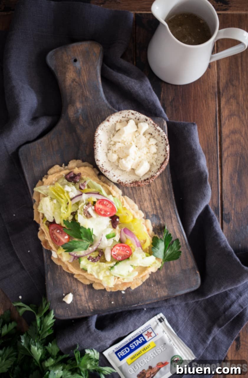 Gluten-Free Greek-Inspired Naan Pizza 2 Gluten-Free Greek Salad Naan Pizza: Gluten-Free Naan smeared with creamy hummus and topped with a mound of fresh Greek salad.