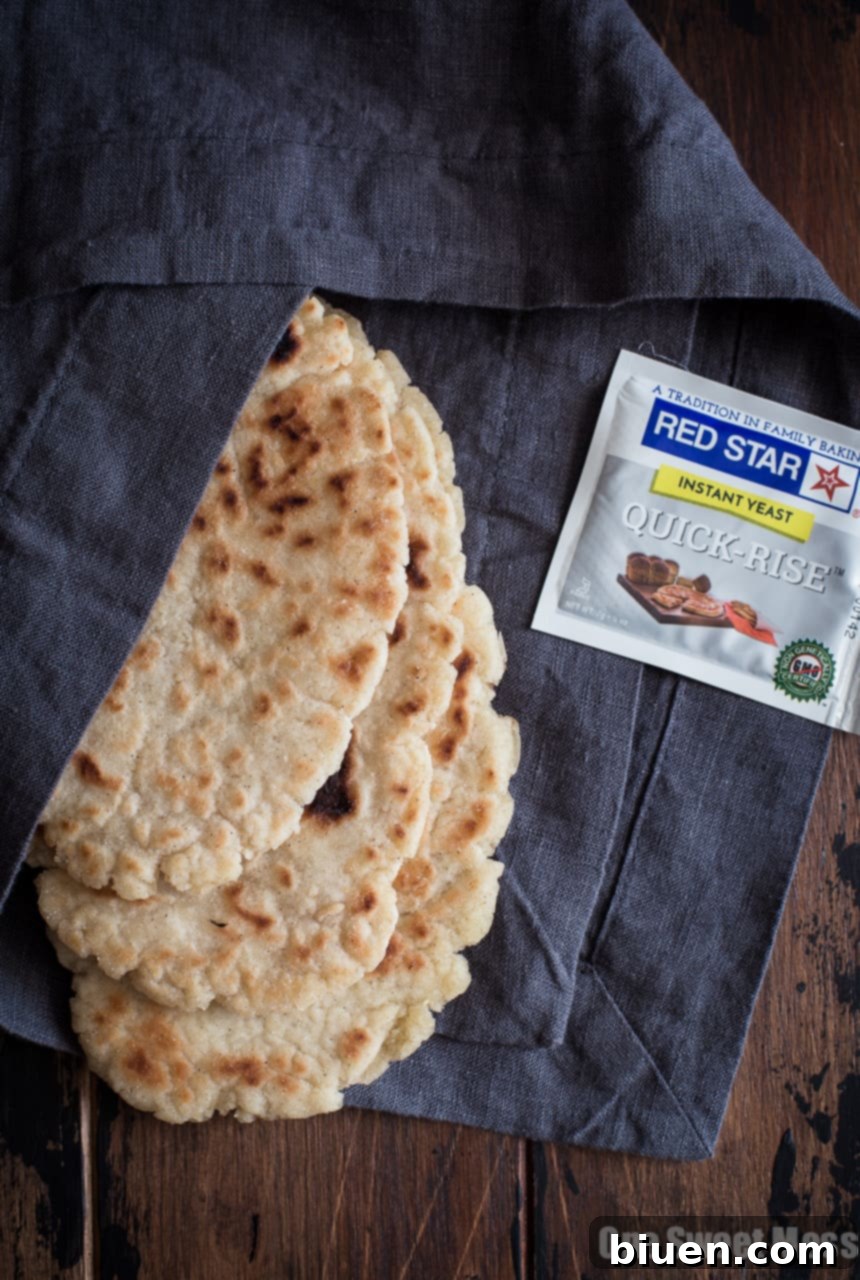 Gluten-Free Greek-Inspired Naan Pizza 4 Gluten-Free Greek Salad Naan Pizza: Gluten-Free Naan smeared with creamy hummus and topped with a mound of fresh Greek salad.