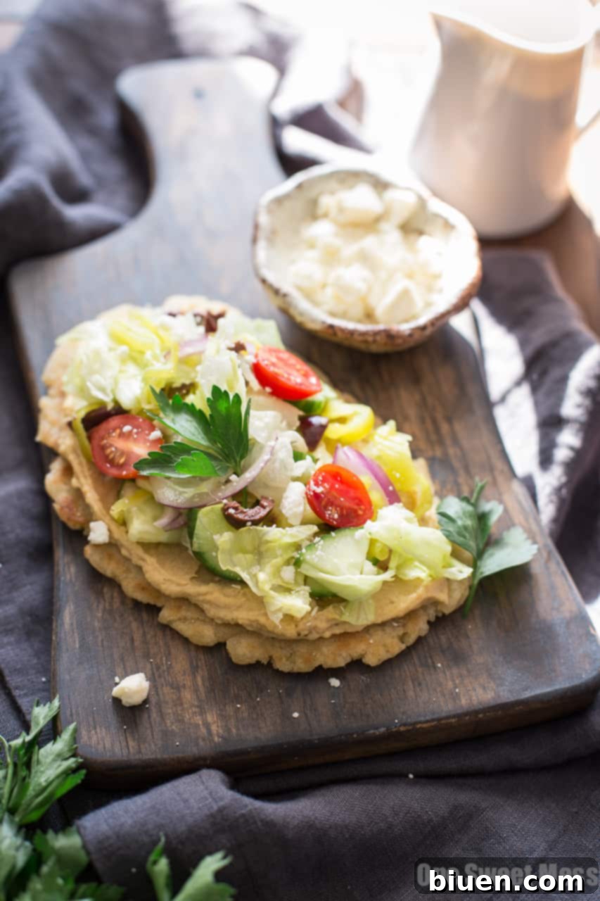 Gluten-Free Greek-Inspired Naan Pizza 5 Gluten-Free Greek Salad Naan Pizza: Gluten-Free Naan smeared with creamy hummus and topped with a mound of fresh Greek salad.