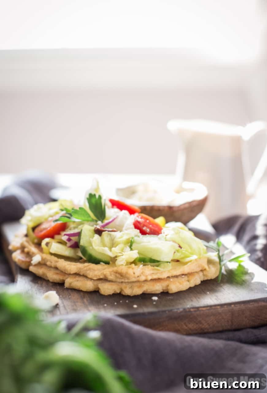 Gluten-Free Greek-Inspired Naan Pizza 6 Gluten-Free Greek Salad Naan Pizza: Gluten-Free Naan smeared with creamy hummus and topped with a mound of fresh Greek salad.