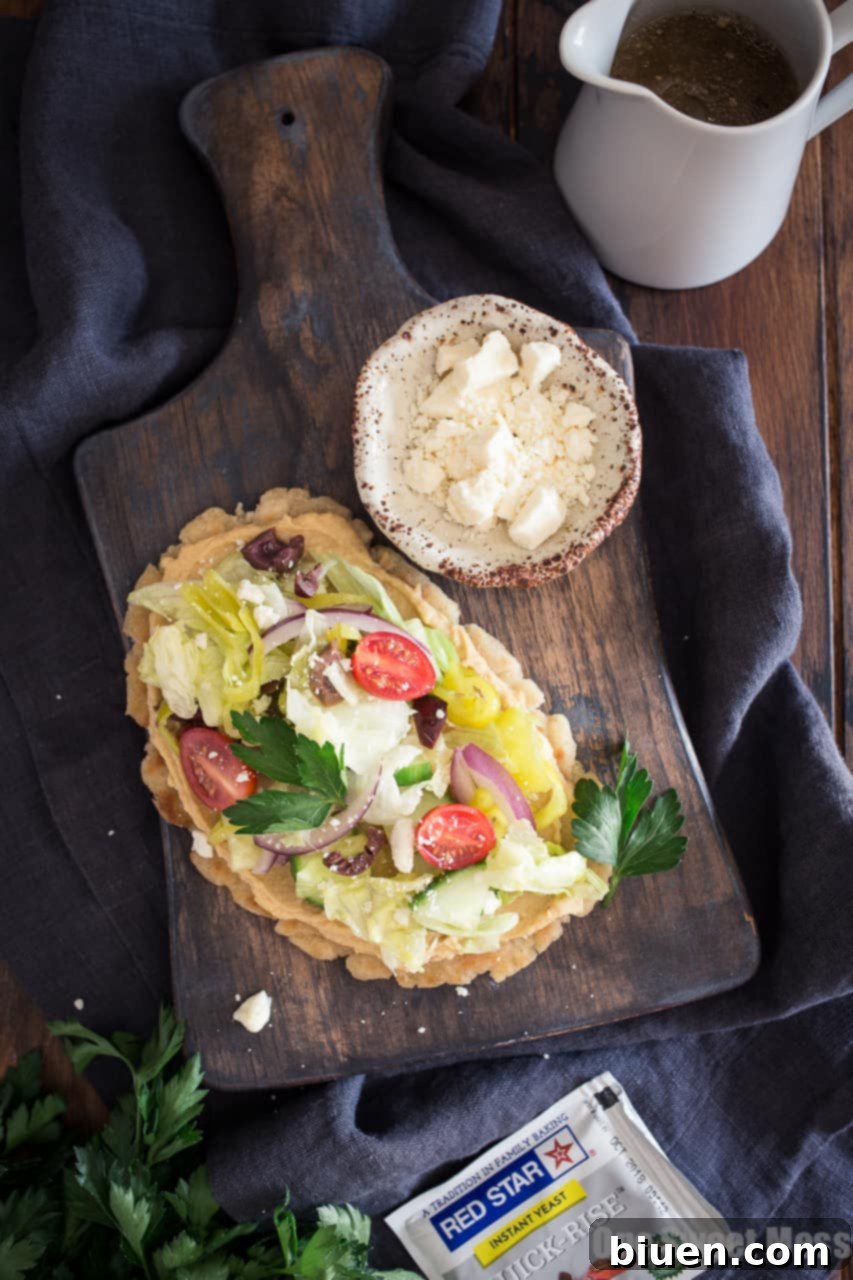 Gluten-Free Greek-Inspired Naan Pizza 7 Gluten-Free Greek Salad Naan Pizza: Gluten-Free Naan smeared with creamy hummus and topped with a mound of fresh Greek salad.