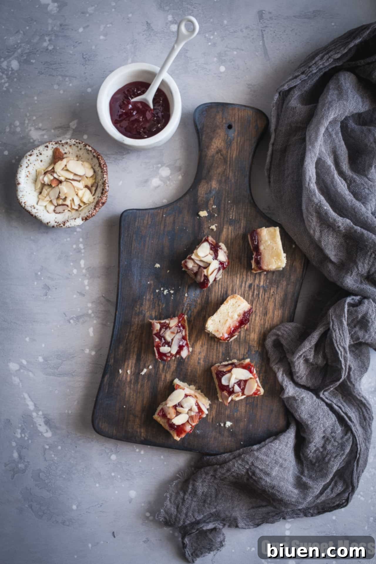 Stack of Gluten-Free Cherry Almond Shortbread Bars on a rustic surface