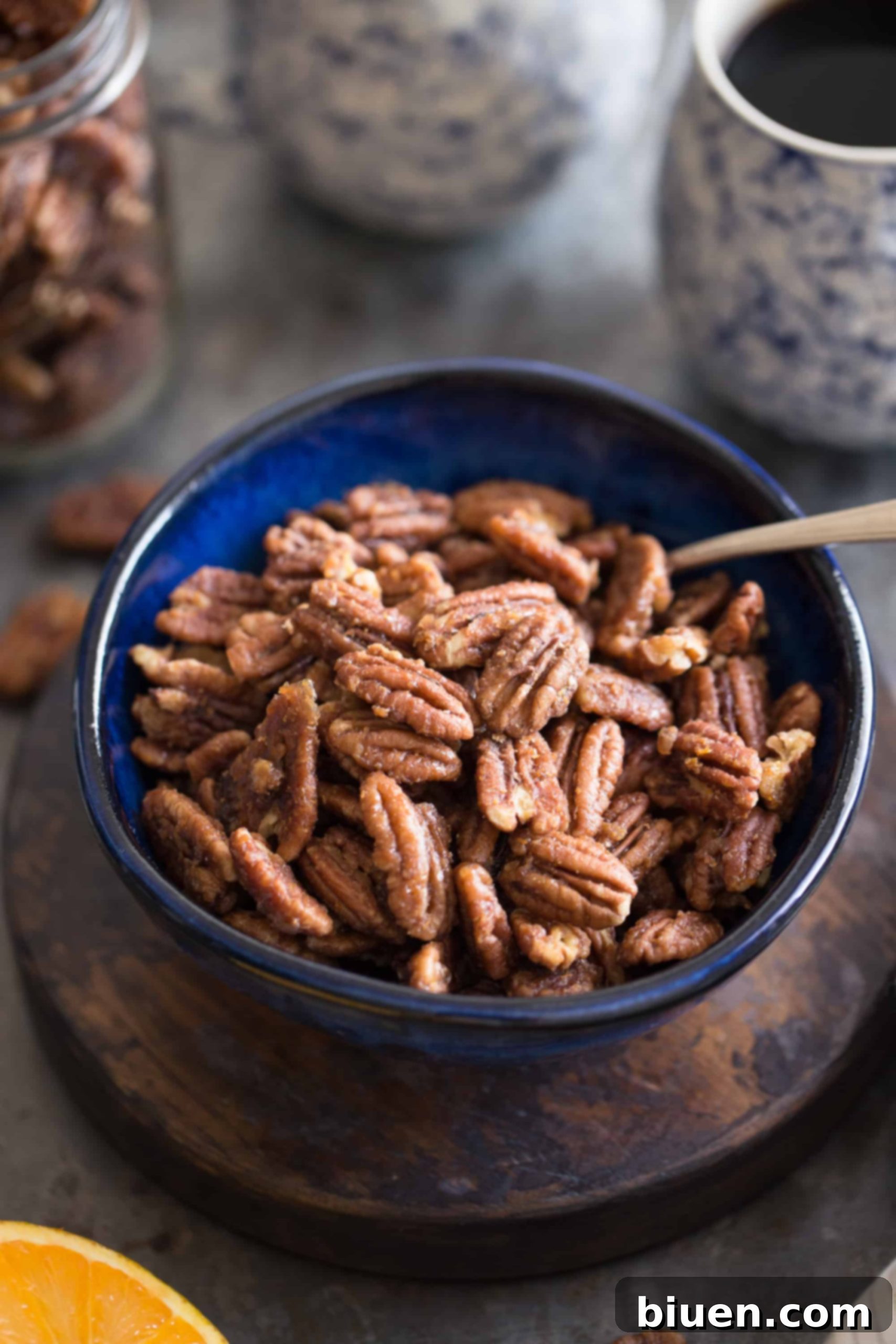 Maple-Orange Glazed Pecans 7 A close-up view of freshly roasted Maple-Orange Pecans, cooling on a baking sheet, ready to be enjoyed.
