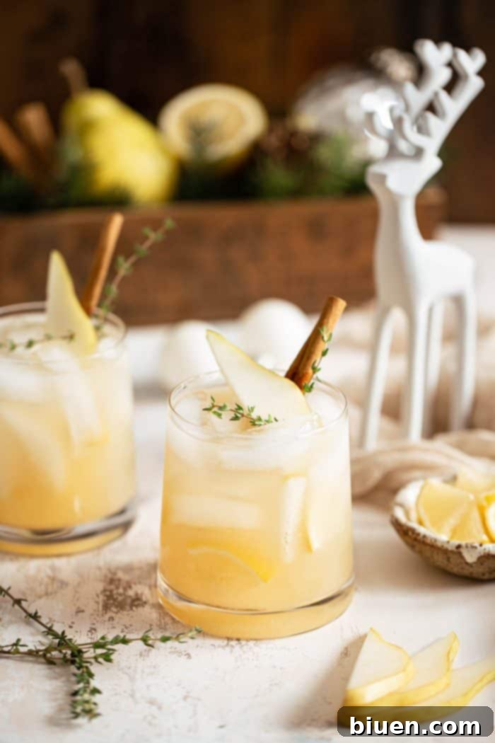 Spiced Pear Gin and Tonic 2 A beautifully garnished Spiced Pear Gin & Tonic cocktail in a glass, ready for holiday celebrations.
