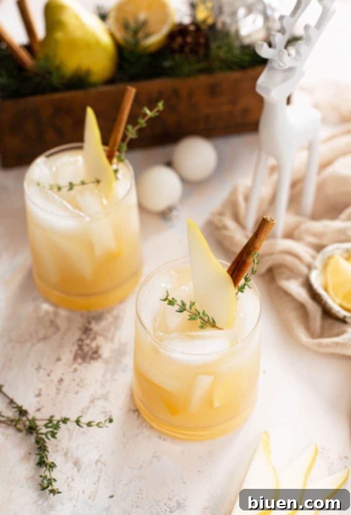 Spiced Pear Gin and Tonic 3 Close-up of a refreshing Spiced Pear Gin & Tonic, highlighting the ice and pear slice garnish.