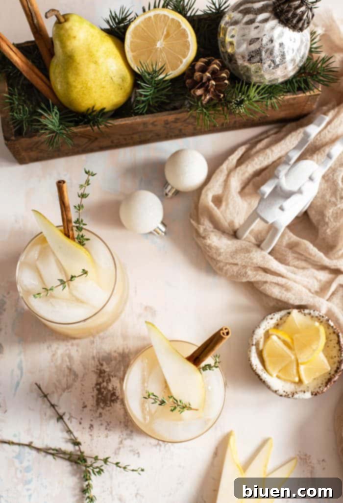 Spiced Pear Gin and Tonic 6 A Spiced Pear Gin & Tonic with ice, a pear slice, and thyme, showcasing its refreshing appeal.