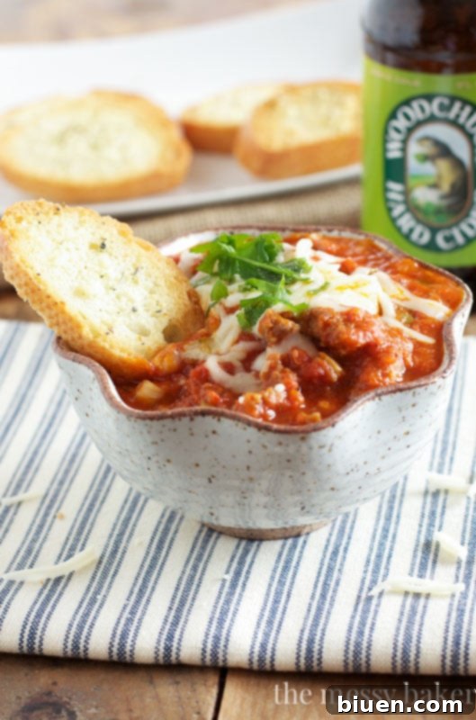 Slow Cooker Pizza Dip with Toasted Garlic Bread Dippers - A cheesy, savory dip perfect for parties and game day.