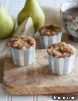 A freshly baked Pear Cinnamon Muffin with streusel topping, ready to be enjoyed.