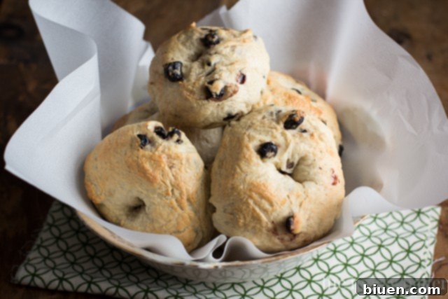 Arrangement of ingredients for Honey Wheat Blueberry Bagels, including flour, yeast, and blueberries