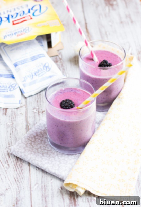 Hands holding a box of Carnation Breakfast Essentials French Vanilla flavor