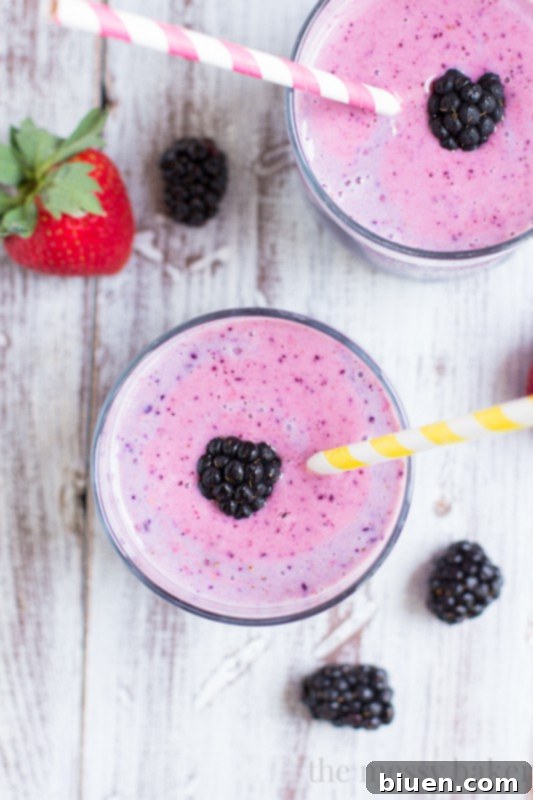 A selection of fresh berries in measuring cups for a smoothie