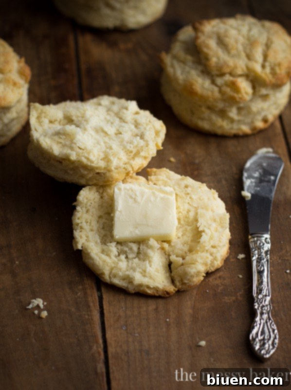 Close-up of fluffy, golden-brown buttermilk biscuits on a baking sheet