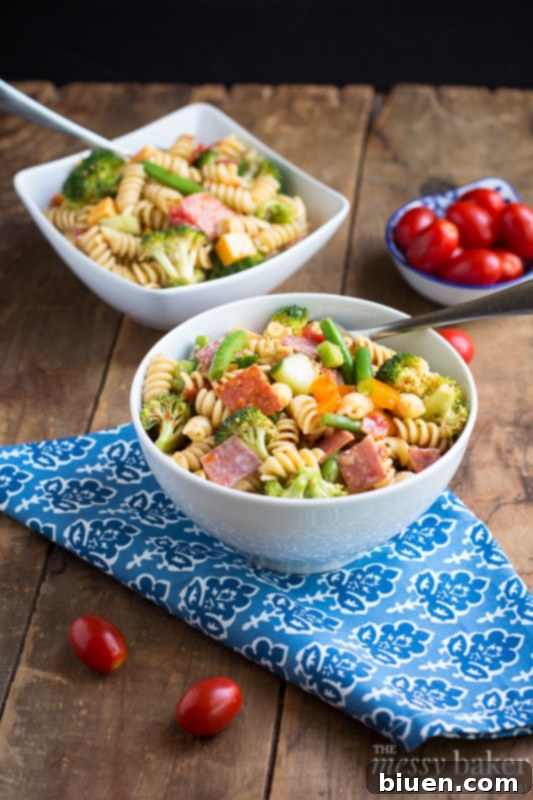 Scoop of colorful Summer Pasta Salad on a plate, ready to be enjoyed