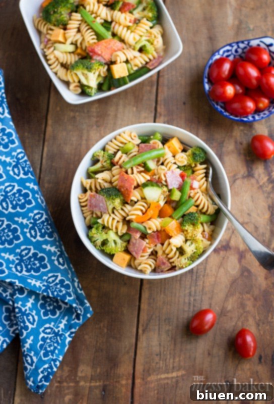 Brightly colored fresh vegetables and pasta waiting to be mixed for the salad
