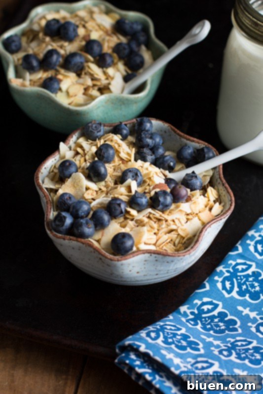 Toasted Coconut Muesli being scooped from a jar